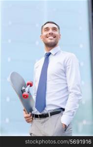 business, hot drinks and people and concept - young smiling businessman with skateboard outdoors