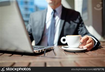business, hot drinks, break and people and concept - senior businessman with laptop computer drinking coffee from espresso cup outdoors. senior businessman with laptop and coffee outdoors