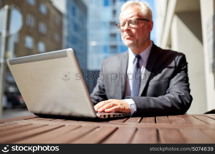 business, hot drinks, technology and people and concept - senior businessman with laptop computer at outdoor cafe. senior businessman with laptop at outdoor cafe