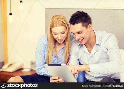 business, hotel, trave and technology concept - smiling couple with tablet pc computer in hotel room