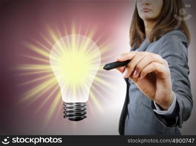 Business idea. Close up of businesswoman drawing bulb with pen
