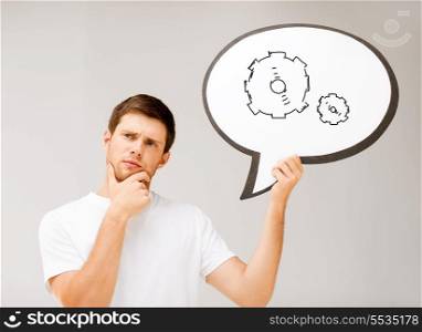 business idea concept - picture of thinking young man with cogwheel in text bubble