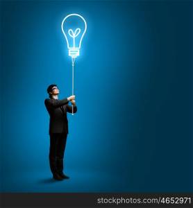 Business idea. Image of businessman with bulb balloon. Inspiration concept