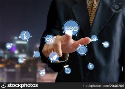 business idea. man touching icon ESG word a virtual screen.Environmental, social, and governance (ESG) investment Organizational growth.