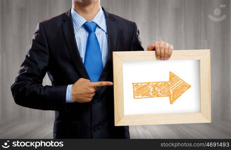 Business ideas. Close up of businessman holding frame with business sketch