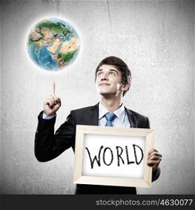 Business ideas. Close up of businessman holding wooden frame. Elements of this image are furnished by NASA