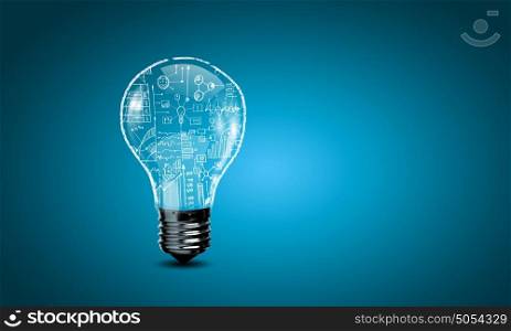 Business ideas. Conceptual image with light bulb and business sketches inside