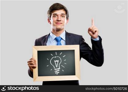 Business ideas. Handsome businessman holding wooden frame with words