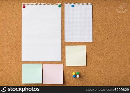 business, information, memo, management and education concept - close up of blank stickers and note paper on office cork board