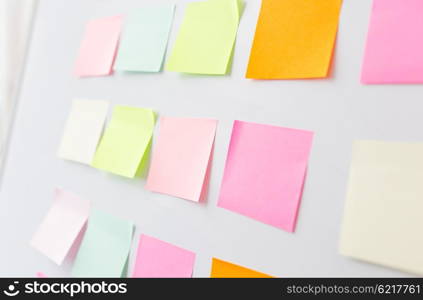 business, information, memo, management and education concept - close up of blank paper stickers on white board