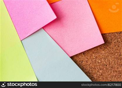 business, information, memo, management and education concept - close up of blank paper stickers on cork board