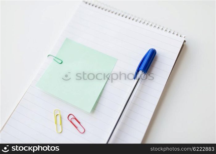 business, information, memo, management and education concept - close up of notebook with pen and bank paper on office table