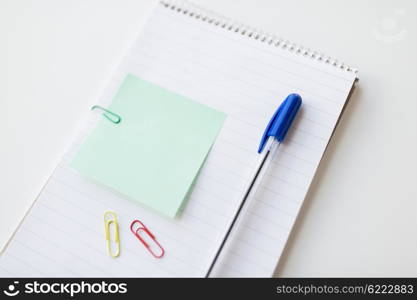 business, information, memo, management and education concept - close up of notebook with pen and bank paper on office table