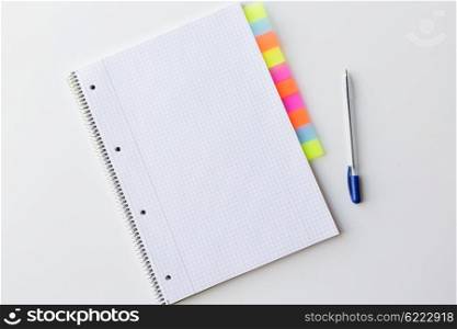 business, information, memo, management and education concept - close up of notebook or organizer with tags and pen on office table