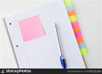 business, information, memo, management and education concept - close up of notebook or organizer with tags and pen on office table