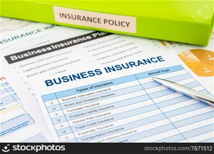 Business insurance planning with checklist forms and document binder, concept for risk management