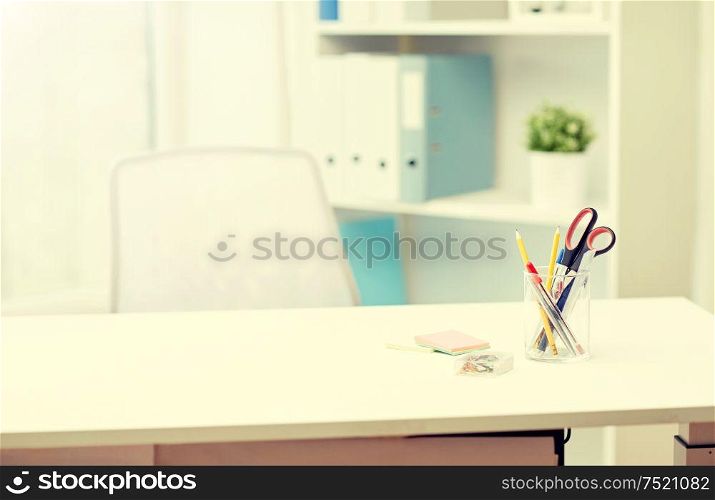 business, interior, workplace and education concept - stationery on office table. stationery on table in office interior