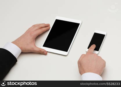 business, internet and technology concept - close up of businessman hands working with table pc and smartphone