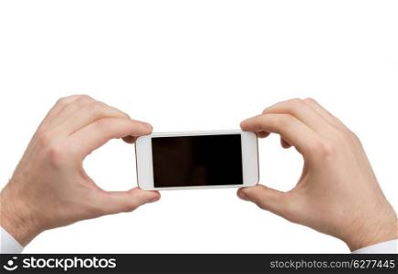 business, internet and technology concept - close up of man hands holding smartphone