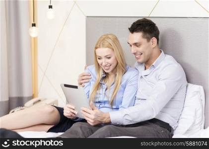 business, internet and technology concept - couple with tablet pc computer in hotel room