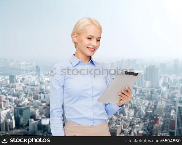 business, internet and technology concept - smiling woman looking at tablet pc computer
