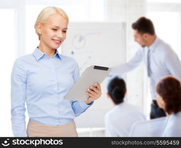 business, internet and technology concept - smiling woman looking at tablet pc computer