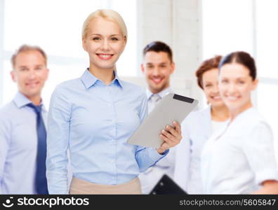 business, internet and technology concept - smiling woman looking at tablet pc computer