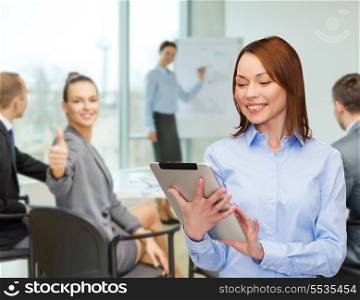 business, internet and technology concept - smiling woman looking at tablet pc computer at office