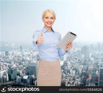 business, internet and technology concept - smiling woman looking at tablet pc computer showing thumbs up