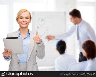 business, internet and technology concept - smiling woman with tablet pc computer showing thumbs up at office