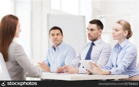 business, interview, employment and office concept - business team with tablet pc computer interviewing or firing worker in office