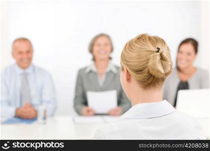 Business interview young woman being examined by professional manager team