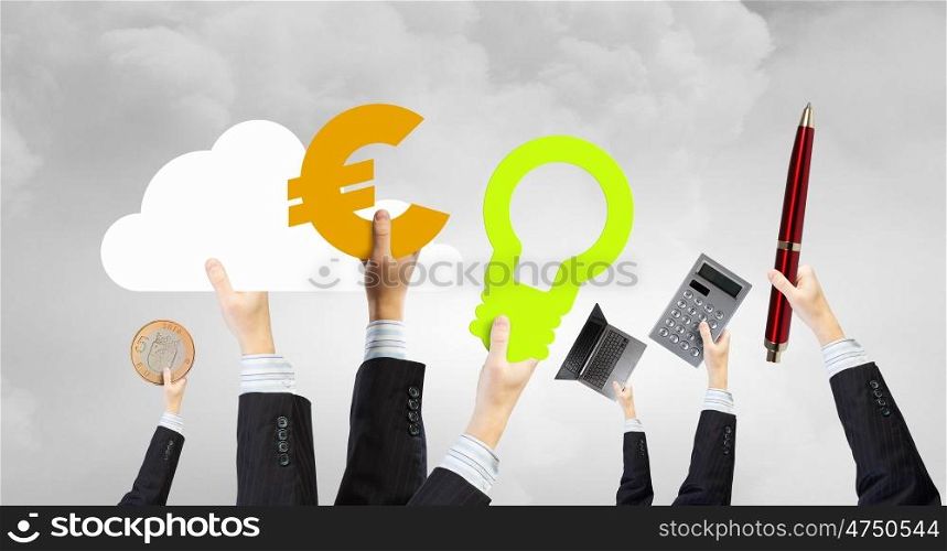 Business items in hands. Group of business people holding business items in raised hands