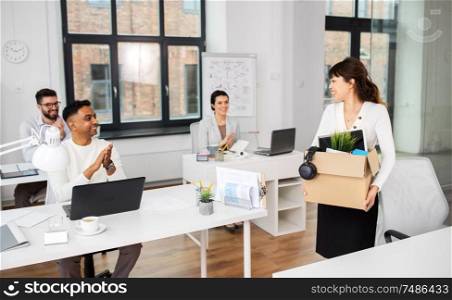 business, job and quit concept - happy smiling colleagues applauding to female office worker. colleagues applauding to female office worker