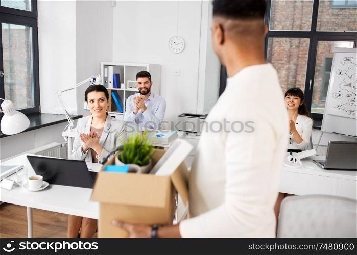 business, job and quit concept - happy smiling colleagues applauding to male office worker. colleagues applauding to male office worker