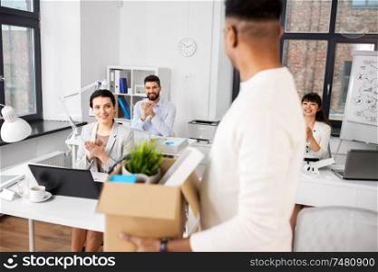 business, job and quit concept - happy smiling colleagues applauding to male office worker. colleagues applauding to male office worker