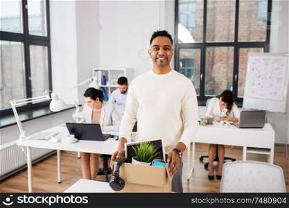 business, job and quit concept - happy smiling indian male office worker with personal stuff. happy male office worker with personal stuff