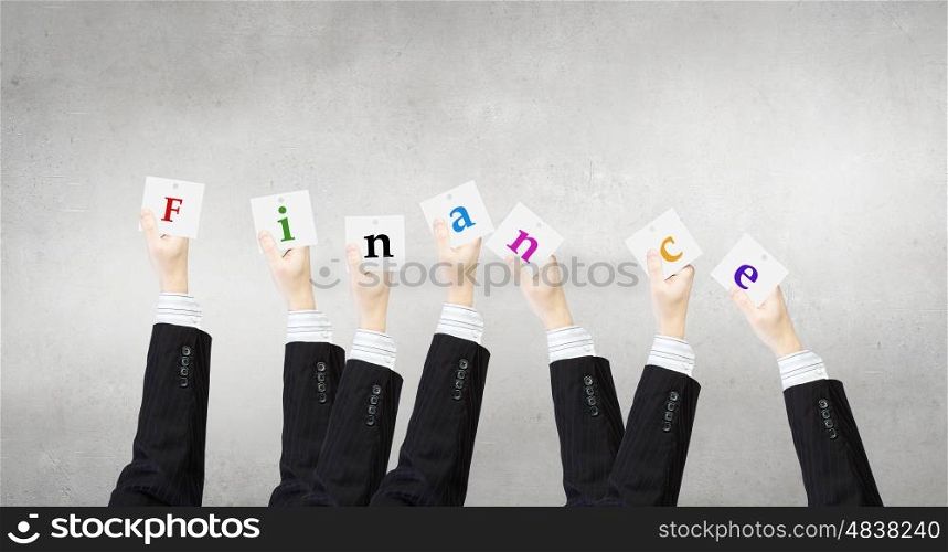 Business keywords. Group of business people holding in hands cards with letters