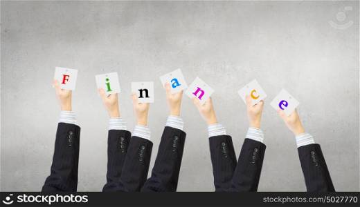 Business keywords. Group of business people holding in hands cards with letters