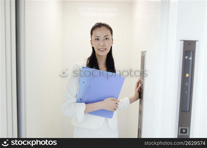 Business lady standing in elevator