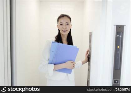 Business lady standing in elevator
