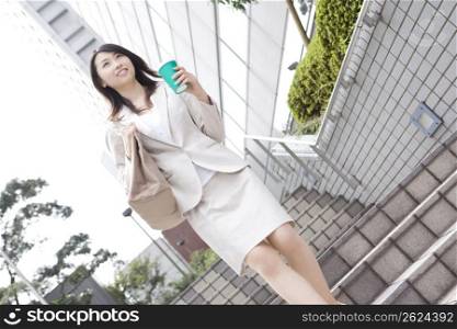 Business lady walking with having a cup