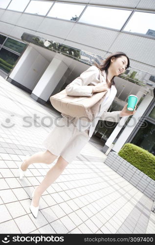 Business lady walking with having a cup