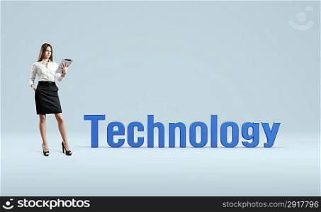 Business lady with tablet pc stand near word technology. Idea concept.