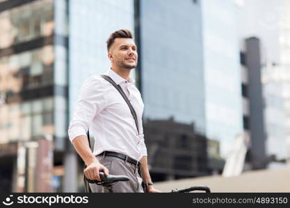 business, lifestyle, transport and people concept - young man with bicycle on city street