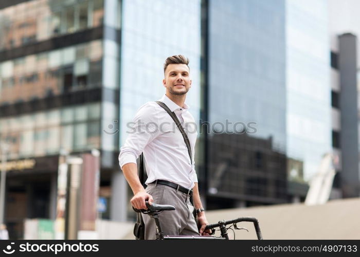 business, lifestyle, transport and people concept - young man with bicycle on city street. young man with bicycle on city street