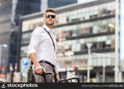 business, lifestyle, transport and people concept - young man with bicycle on city street. young man with bicycle on city street