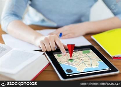 business, location, navigation, technology and internet concept - close up of student woman with gps navigator map on tablet pc computer and notebook at home