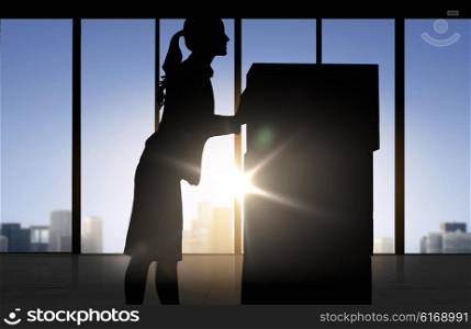 business, logistics, transportation and shipment people concept - silhouette of businesswoman moving boxes over office window background