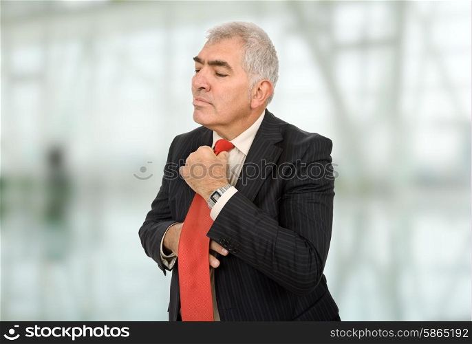 business man adjusting his tie at the office